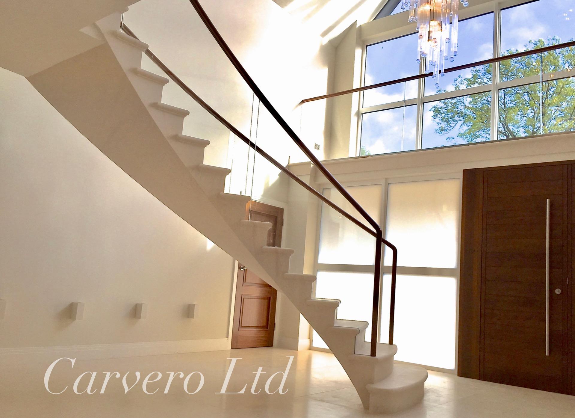 A stunning floating limestone staircase - post tensioned stone staircase in Surrey by Carvero