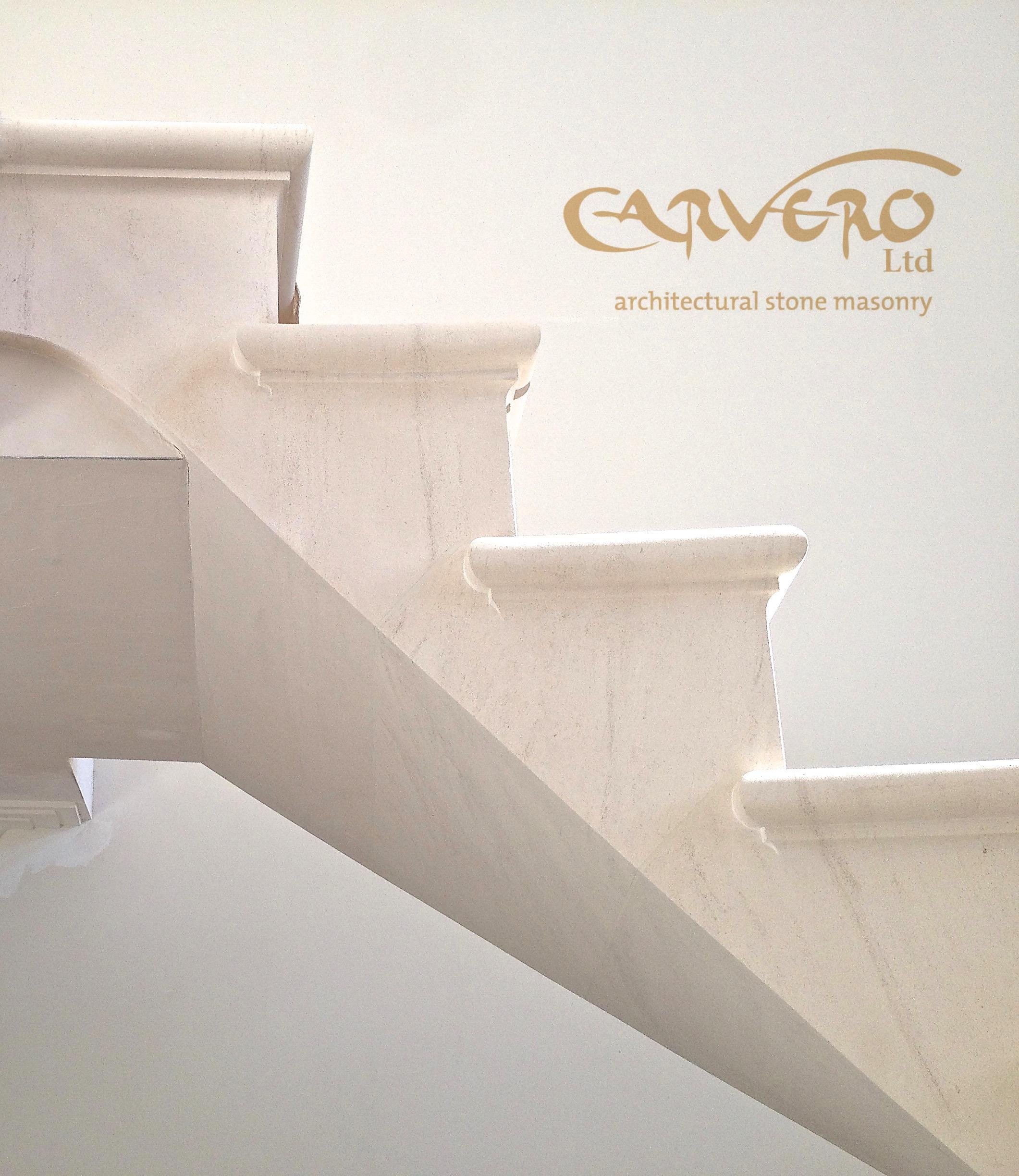 Floating post-tensioned limestone staircase in Warlingham, Surrey with glass balustrade and timber handrail, by Carverohy