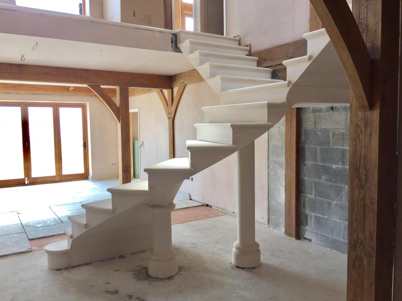 Floating post tensioned stone staircase
