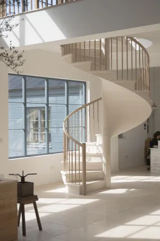 exceptional spiral staircase in limestone at the deVOL kitchens showroom in Leicestershire